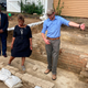 Reginald F. Davis, from left, pastor of First Baptist Church in Williamsburg, Connie Matthews Harshaw, a member of First Baptist, and Jack Gary, Colonial Williamsburg’s director of archaeology, stand at the brick-and-mortar foundation of one the oldest Black churches in the U.S. on Wednesday, Oct. 6, 2021, in Williamsburg, Va. Colonial Williamsburg announced Thursday Oct. 7, that the foundation had been unearthed by archeologists.